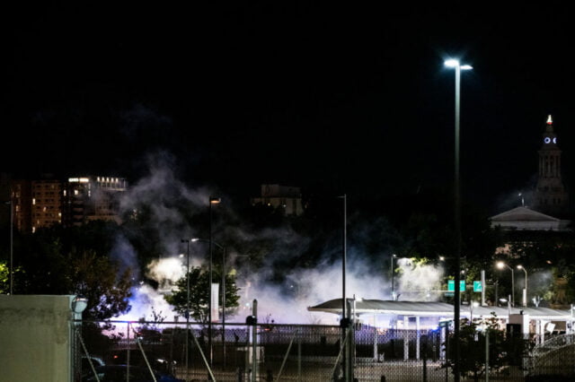 Night time view of smoke over protest site.