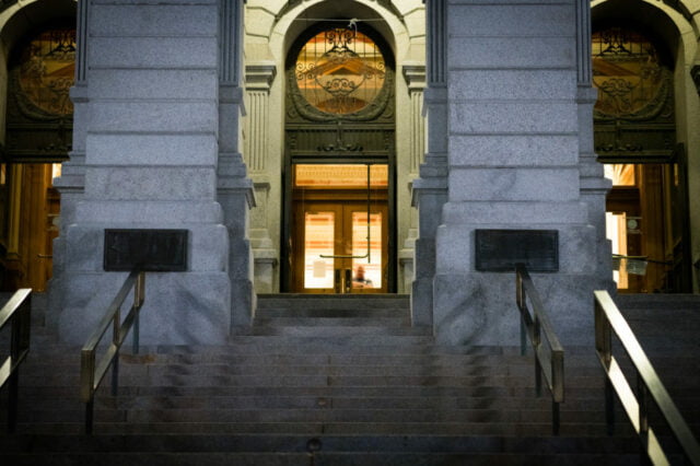 Night time view of the front door of the Denver capitol and stairs.
