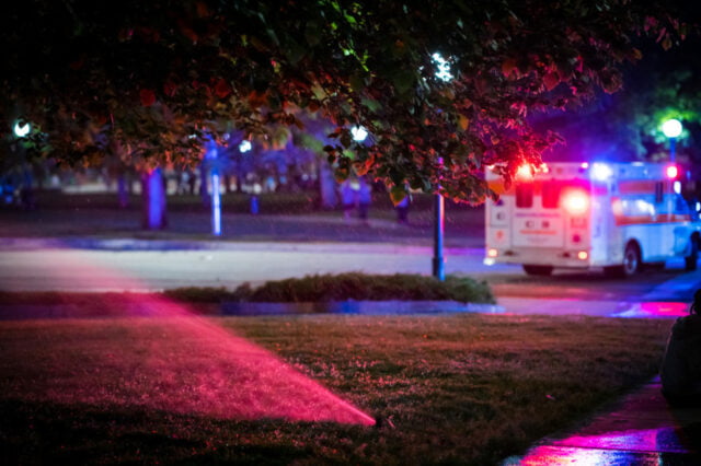 The emergency vehicles in the background.