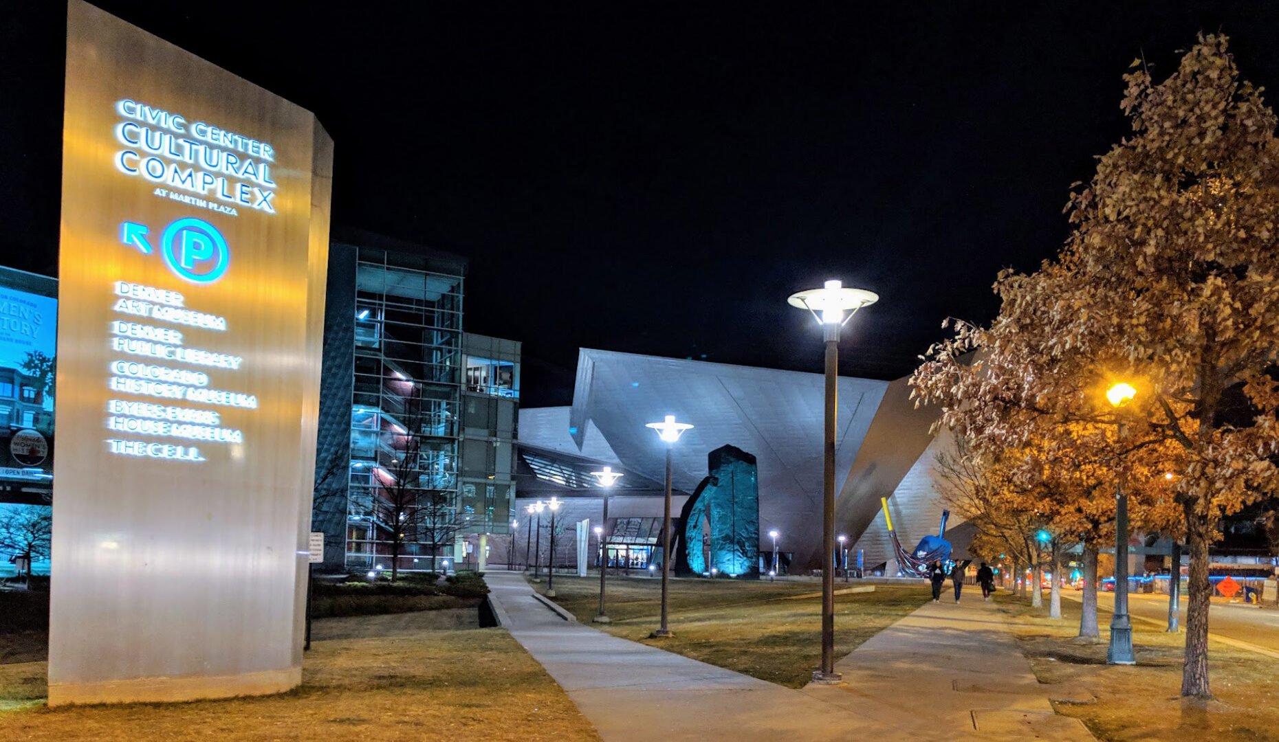 outside of the civic center cultural complex at night. directional sign showing parking location
