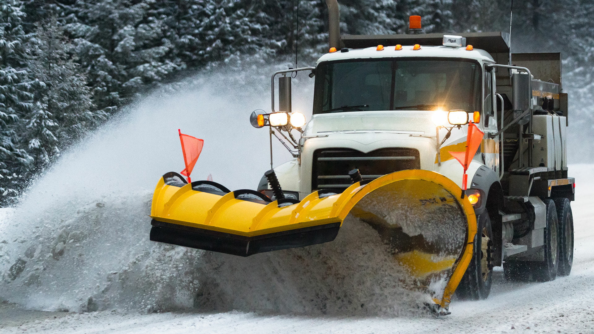 Denver snow plow pushes snow built up on the road to the shoulder