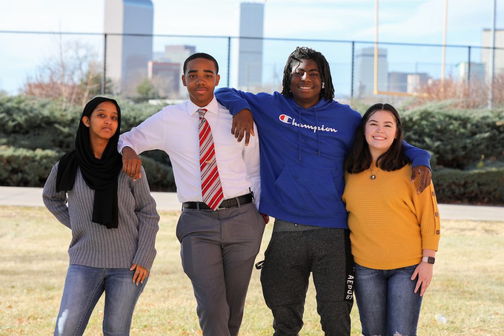 4 DPS Students with Denver Skyline